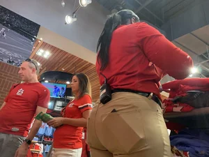 Bunch of girls in various outfits at a Cardinals baseball game