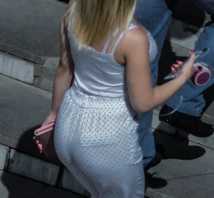 Awesome blonde candid chick wearing white polka-dot pants passing by on the street, closeup of her ass