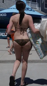 Girl in a tiny brown floral bikini showing some cheek and crack