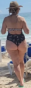 Milf in bikini with her friend at the beach bar