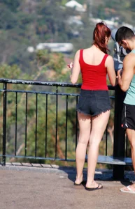 Redhead beauty in short shorts showing some cheeks and panties