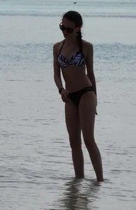 Two candid skinny teen sisters in bikinis