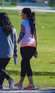 Thick lady walking in leggings with a big booty