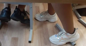 Legs of candid college teens wearing pantyhose in class