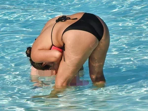 Sexy milf with a nice mom bod in a bikini in the pool