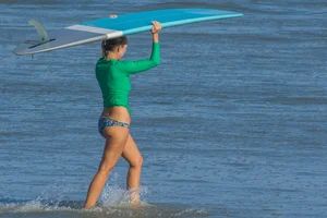 Candid girls surfing on the beach