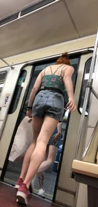 Two Girls With Hot Long Legs in Mini Shorts and Sneakers in the Subway Train Candid Photo Gallery