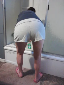 Girl in Shorts Bending Over While Cleaning Bath