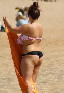 Thick girl on the beach with big boobs and a big booty