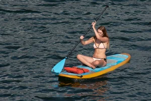 Tall, busty redhead in a skimpy bikini
