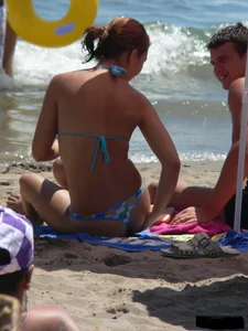 A bunch of hot babes on the beach in thong bikinis
