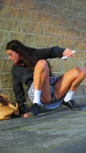 Girl Sitting on the Floor in a Skirt Revealing Panties While Standing Up