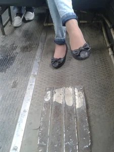 Feet in Pantyhose and Flats Closeup in a Public Bus