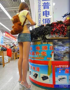 Awesome Very Skinny Girl on High Heeled Shoes in a Denim Mini Skirt and a Top at the Supermarket Creepshot
