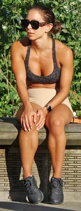 Tanned fitness woman showing off her toned physique & amazing butt