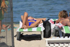 A couple sexy girls laying out on the beach