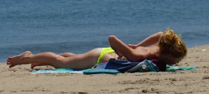 Sexy ass blonde milf on the beach in a thong with cameltoe and bending over