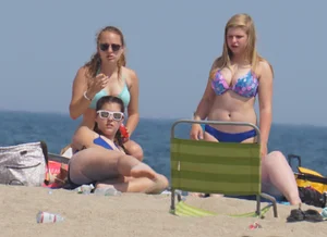 3 girls on the beach in bikinis with big boobs, one brunette and two blondes