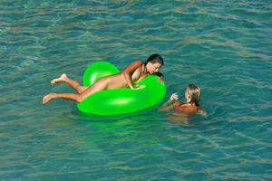 FKK Nudists playing in the water with floater