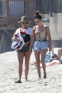 Ashley Tisdale in cheetah print swimsuit on the beach in Malibu