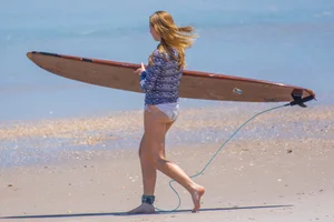 Candid girls surfing on the beach