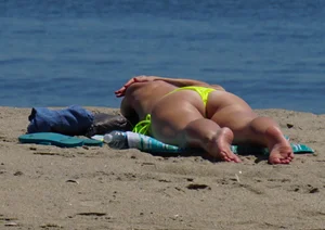 Sexy ass blonde milf on the beach in a thong with cameltoe and bending over