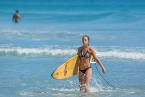 Candid girls surfing on the beach