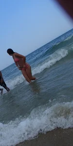 Pierced nipples hottie in pink at the beach