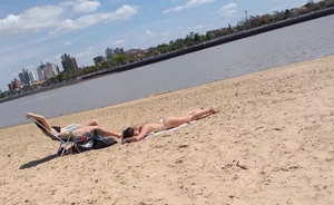 Girl laying out getting sun in a white thong bikini