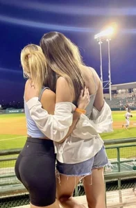 Couple of hot girls hugging at the stadium