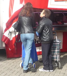 Nice girl in a leather jacket and blue jeans street creepshot