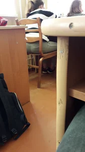 Candid college teen wearing tight jeans sitting at her desk in class, tight ass