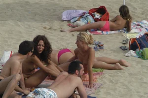 Topless girls on a beach in Barcelona