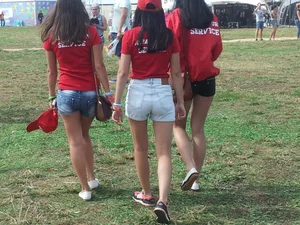Group of Young Candid Girls Walking on the Grass in the Park