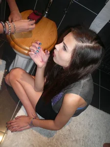 Girl sitting on the floor in the toilet