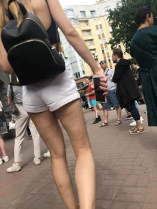 Hot Candid Girl in a Top, Shorts and Sneakers Skinny Legs Closeup Creepshots Gallery on the City Street