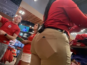 Bunch of girls in various outfits at a Cardinals baseball game