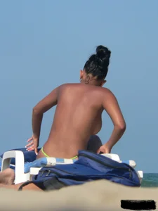 Hot ass topless beach girl with great tits lets her little brother oil up her ass in thong bikini