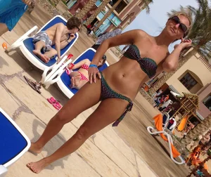 Sexy blonde babe in a bikini at the pool