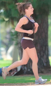 Cute girl running in short shorts