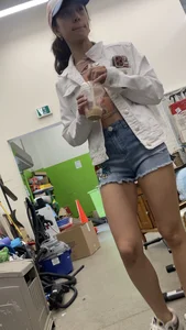 Tight bum hanging out of jean shorts in thrift shop