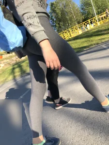 Skinny Girl in Grey Leggings Walking Past the Camera Candid Photos Gallery
