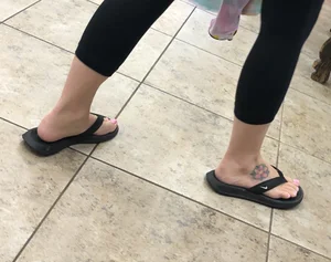 Tattooed Feet in Slippers Candid Closeup