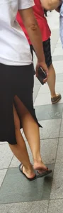Mature Wife's Legs And Feet in Flip-Flops on the Street