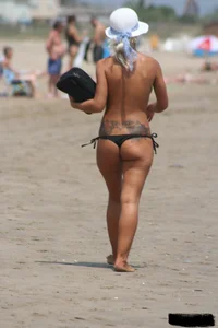 Tattooed blonde with big tits topless and in thong