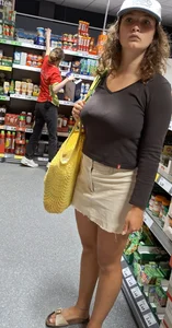Curly haired woman with huge tits and nice legs