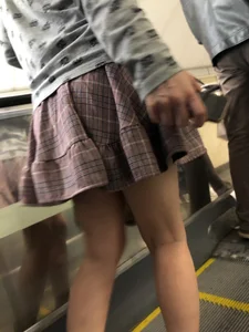 Stocky Girl in a Checkered Skirt on the Escalator Legs Closeup Creepshots