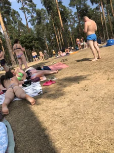 Pale Girl in Swimsuit Lying on a Lake Beach With Her Friends Creepshots Gallery