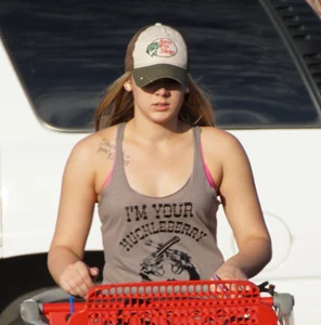 Hot blonde after shopping in short jean shorts and tank top
