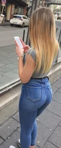 A few girls with tight asses in jeans waiting for